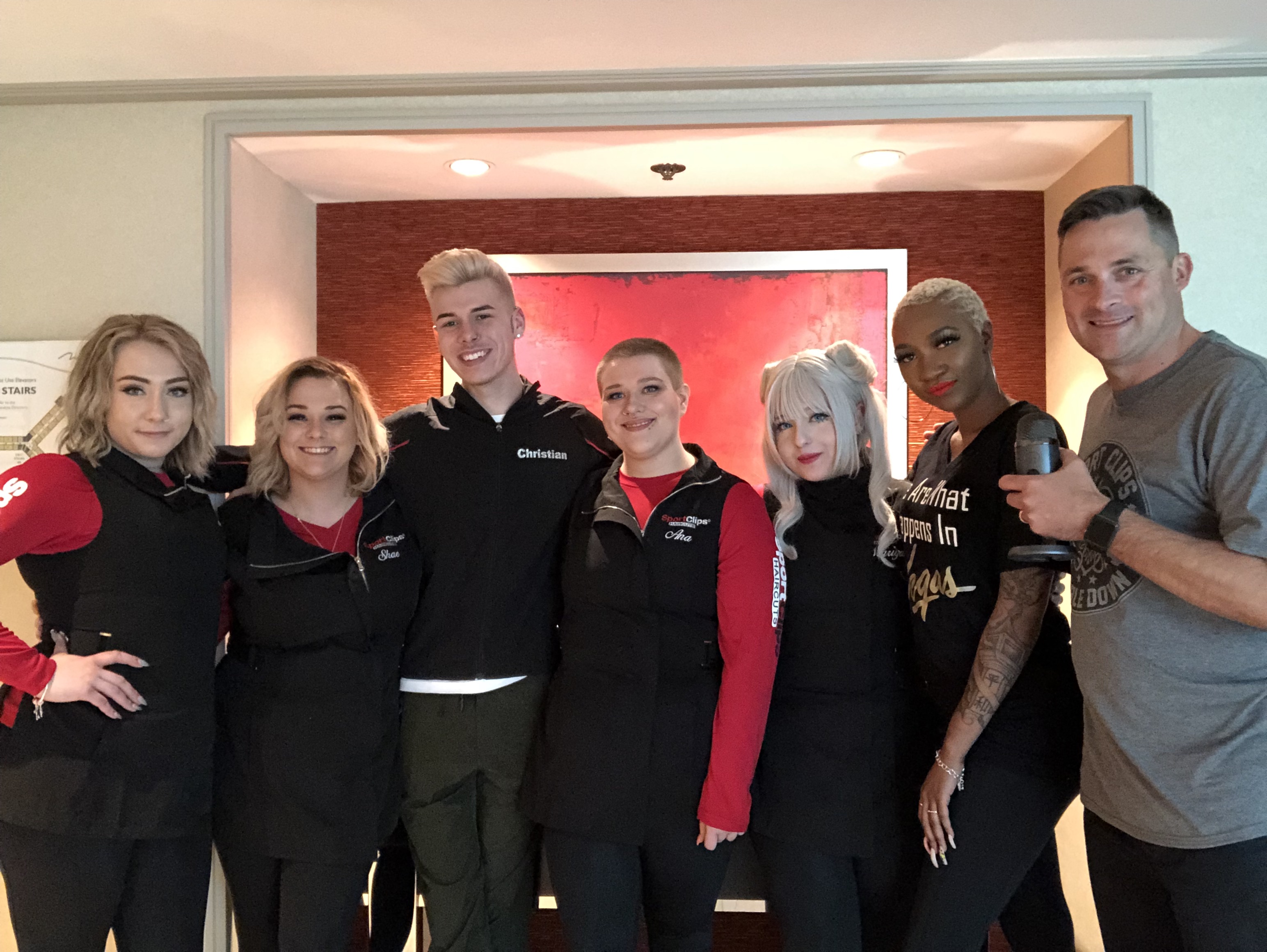 The 6 Look Finalists and Chad Jordan holding a microphone